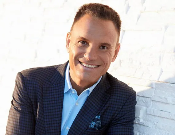 Kevin Harrington holding Restore Naturals products